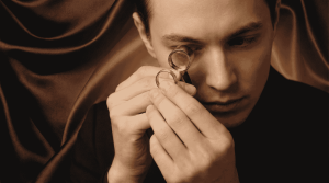 Henkilö tarkastelee kultasormusta